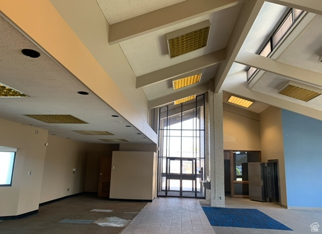 Lobby with a high ceiling and beam ceiling