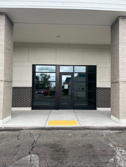 Entrance to property featuring brick siding