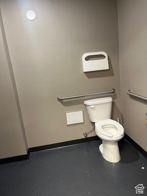Half bath with toilet and baseboards