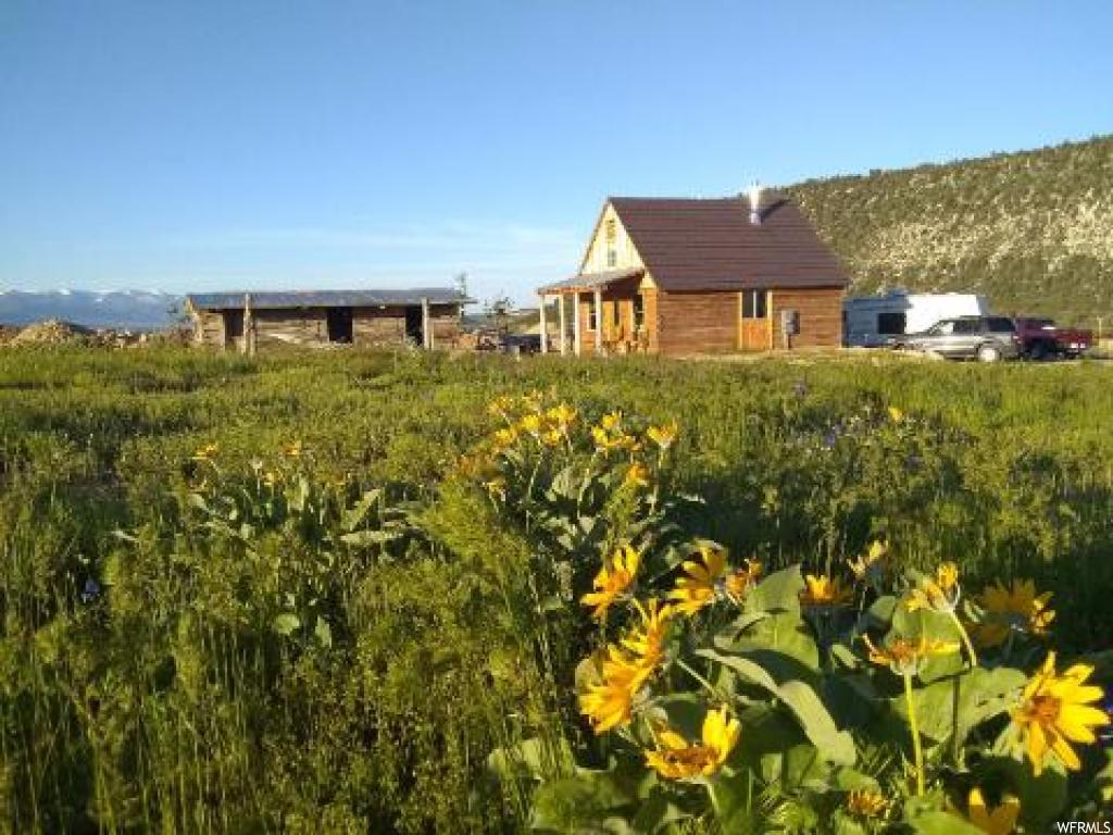 28700 11150 E N Fairview, Utah NEW LOWERED PRICE! Beautiful 3.5 acres with stunning panoramic views! Comes with cozy custom built log cabin built with hand hewn authentic pioneer logs. Master bed with 1/2 bath. 2nd bedroom has a small loft with a queen bed. Basement has a separate outside entrance and is used for storage only. It includes a lot of storage shelving and an 1100 gallon water tank. Has an amazing well with great tasting water and 16 fruit trees. Out buildings include a pioneer log barn, storage shed, and an additional 3 room log building. Comes with a large dog kennel and 2 fenced pastures. There is also an RV hookup. Bring your animals and your toys! Snowmobiling, 4-wheeling and horseback riding right on your own property with access to equestrian and other trails that access Skyline Dr/Manti National Forest. Square footage figures are provided as a courtesy estimate only and were obtained from sellers measurement. Buyer is advised to obtain an independent measurement. Agent is related to seller.
