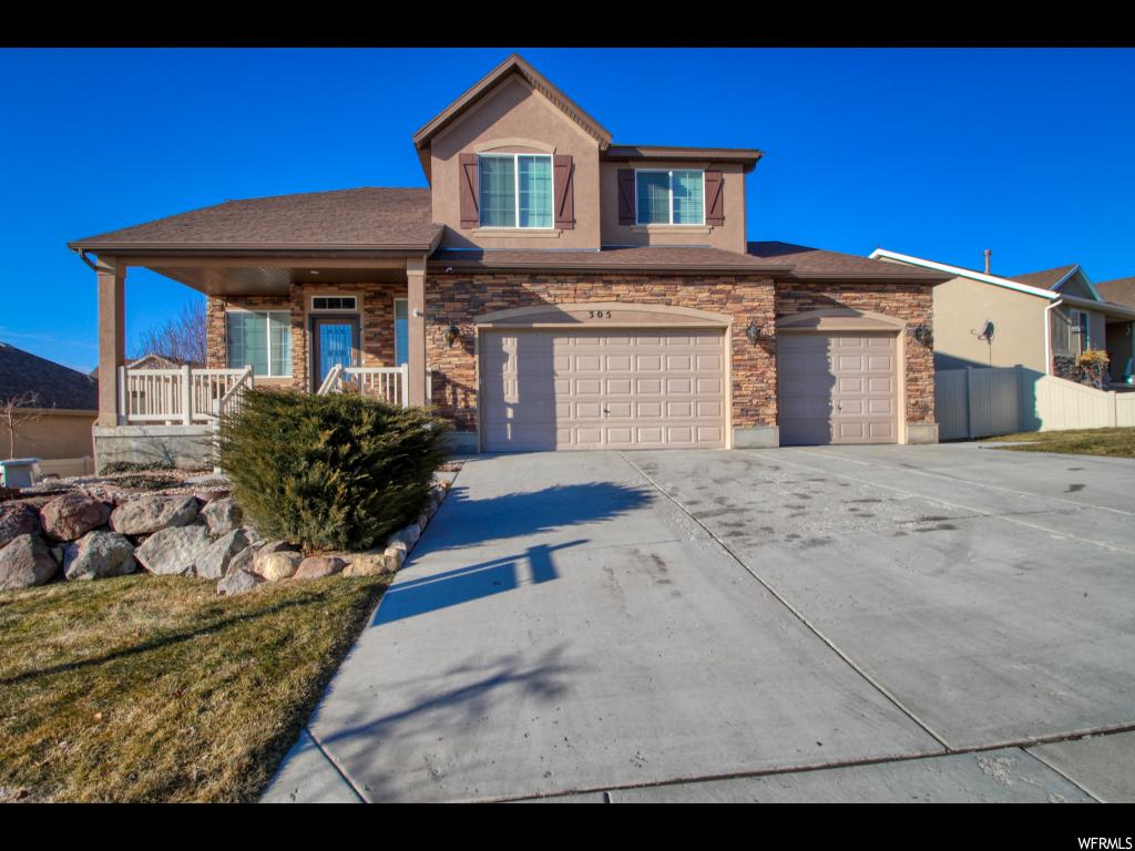 305 W RYE DR Saratoga Springs, Utah Live in one of Saratoga Springs premier neighborhoods close to everything! Shopping, Thanksgiving Point, I-15 - easy commutes to Salt Lake or Provo!! Large trees, spacious parks and nature trails all close to home, with plans for a community pool to be added soon! **This ELEGANTLY upgraded Harvest Hills home offers quality craftsmanship and beautiful finishes throughout. Gorgeous custom glass front entry door, exterior stone work, four total living areas including a loft, 9 foot ceilings, granite countertops, beautiful barn style door in kitchen that makes a statement, porcelain wood look tile flooring throughout the main floor, high quality lighting and upgraded fixtures, new carpeting and custom stone, tile, and woodwork abounds in this home. Three bedrooms up including a large master retreat with updated on suite bath, as well as large loft area overlooking the front living room. **STUNNING main floor has all the room you need for entertaining, including a formal living room, family room, gas fireplace, dining area, a spacious kitchen, laundry room, and a bonus mud room with plenty of storage space. The basement is 100% finished, perfect for an additional family area, complete with two bedrooms, a kitchenette, and nicely sized family room with in ceiling speakers! Walk out to the perfect fully fenced backyard, complete with mature trees a large covered patio; also wired for a hot tub. Or hang out on the huge deck right off the kitchen and enjoy the beautiful views! Don't forget the large driveway, 3-car garage, and tons of bonus overhead storage racks throughout the entire garage space.** And the local elementary schools offers a desirable language immersion program for both Spanish and Mandarin. Buyer/Buyer broker to verify all information provided including square footage.
