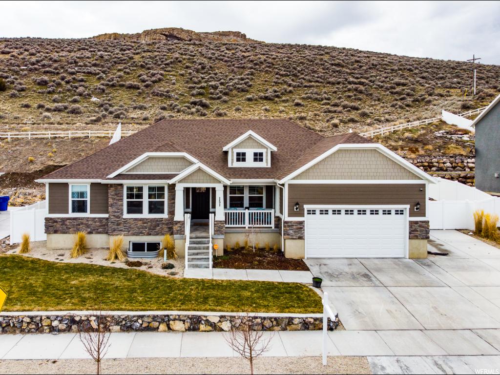 151 W PARKSIDE DR Saratoga Springs, Utah This beautiful rambler is situated in a great location away from the busyness of Northern Utah County but still close to everything! It is walking distance to the elementary school and many parks in the neighborhood. Enjoy not having backyard neighbors. The hillside behind provides a beautiful backdrop to the home and yard making it feel even more quiet and peaceful. Boasts attractive landscaping that maximizes all of the usable yard space. Large bedrooms and fantastic open concept floor plan with a spacious great room make it excellent for family and entertaining friends. Many other desirable features include: quartz kitchen countertops; nice pantry; tray ceiling in master bedroom; and grand master bath with separate tub & shower. Must see!