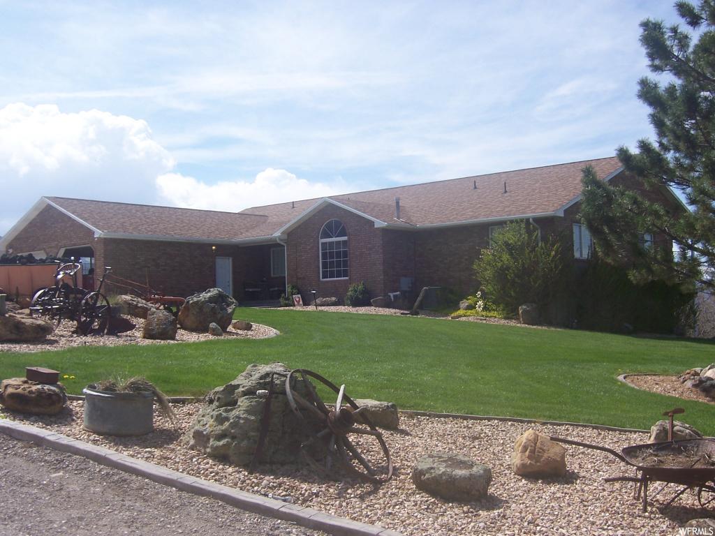 24750 11950 E N Fairview, Utah Fantastic brick home on .92 acres in Fairview Heights. Prime lot with superb views. Large Kitchen, dining area & great room. New pantry, mud & laundry rooms with custom cabinets. Formal living room and remodeled master suite. Toy room that can be office or 6th bedroom. Abundant closets. Walkout basement with family room, 4 bedrooms, full bath, large storage closets and indoor basketball court. Attached double garage. Full length deck and covered patio, kids play area and patio with water fountain. 2 metal garages, 20'x30' & 30'x40'. Shop contents are excluded as is the coal car and some other items in the yard. This is a must see home with so much to offer.