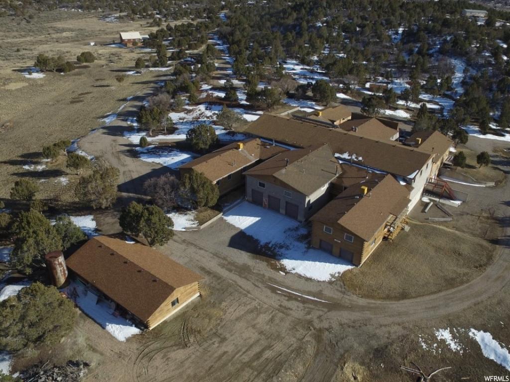 34550 10340 E N Fairview, Utah Mountain Retreat in Utah (3) Parcels included in sale, Tax parcel numbers: #40156 (31.68 acres); #40158 (5 acres); #40161 (2.81 acres) these three combined total 39.49 acres. 29 Bedrooms 25 total bathrooms and 6 Kitchens Approx. 23,949 sq. feet of finished living space, then add 8,000 sq. feet for the Center Court Area, add the sq. footage for the racquetball Court, and add the sq. footage for the Conservatory! Still need more space?! No problem... Barn is 1500 sq. feet and has (2) overhead doors; also property has a 350 sq. foot Care Takers Lodge that is configured like a studio with kitchenette, and full bathroom (not calculated in specifications above). As for the living space, think of this home as 5 individual homes, and a large communal area referred to as the "Ballroom" connected to a common large Center Court area. Each of those spaces can be completely locked off from one another. Each of the individual living spaces are complete with its own forced air furnace, Wood Burning Stove and/or Fireplace, roof mount Swamp Cooler, Kitchen, Garage, and Front Door entry. Ballroom has central air conditioning. Center Court Area has elevator type lift for ease of moving items to second floor. Home has solar w/ batteries but is also connected to the grid and to make sure you never go without power it has a 17000 kw generator as backup! One of the multiple garages is set up for RV's with (3) 13' overhead doors and extra length. Lot runs fairly flat, is easily accessible with a gravel and dirt driveway that circles the property making it very user friendly. Property is private and secluded with lots of space, has lots of trees and beautiful views of the surrounding mountains and valley. Location of property is a 90 min. drive from Salt Lake City and only a 35 min. drive to the Costco in Spanish Fork! Water is supplied from a well and the home has a 6000 gal storage tank. Homes gas source comes from a very large single propane tank. Current owners only need to have propane tank filled once a year! Oh, I almost forgot, property also has a well-built large chicken coop! Much of the furnishings is negotiable and can be purchased at an additional cost; seller will provide a Bill of Sale for any personal property sold to Buyers. This property is also being listed on the WFR MLS under the Multi Unit section MLS#1591654 Square footage figures are provided as a courtesy estimate only and were obtained from Seller. Buyer is advised to obtain an independent measurement in addition to verifying all specifics of property.