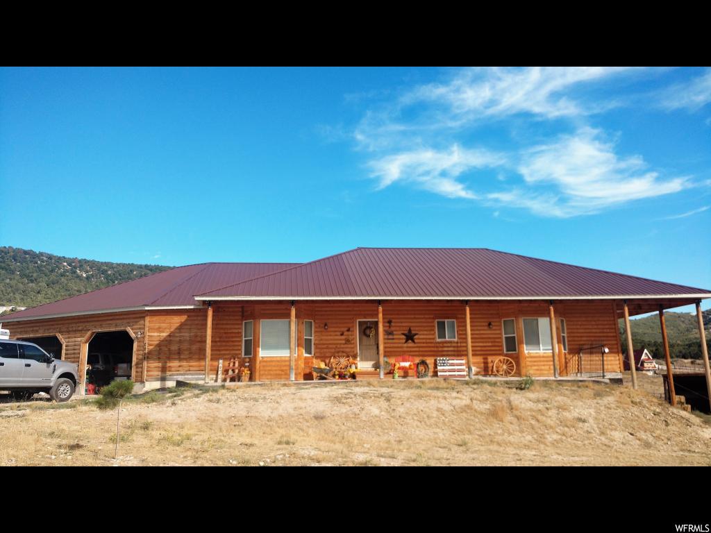 10470 34840 N E Fairview, Utah Half log siding w/ covered front&back porch sitting on 2.96 acres of Horse Property.Open Rambler Plan,2x6 Walls,Vaulted Ceilings,9' Basement Walls,Great Room,Spacious Kitchen,Mudroom,Laundry Room upstairs. Huge Garage with Hot/Cold water lines,gas line,large workbench area&space to park ATV's. Pole Barn w/electricity&water spicket. Property has lots of parking/storage space, room to grow. Close proximity to camping,hunting,riding trails&riding tracks. 30 minutes from Spanish Fork. Square footage figures are provided as a courtesy estimate only. Buyer is advised to obtain an independent measurement.