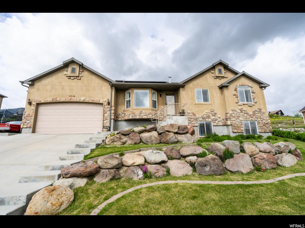 3713 S SUNRISE DR W Saratoga Springs, Utah Welcome to the amazing community of south Saratoga Springs where the air is clean and neighbors are friendly! This wonderful home has so many great features that set it apart from all the others. Fully paid off solar panel system with home battery pack, a double burning wood stove that allows you to burn even on red days, hydraulic wood splitter for all your wood, air compressor in the garage that supplies air for the workshop in the basement and garage, hundreds of dollars worth of shelving in the basement storage rooms stays with the home as well. AMAZING, right? We haven't even begun to talk about the stainless steel appliances that come with the home, granite counter tops throughout, the 4 bedrooms, 3 full baths and the amazing back yard that comes with a huge covered patio perfect for hosting family and friends. Zoning is such that you do not have neighbors behind you! Beautiful views of the Wasatch Mountains, lots of privacy and a wonderful home with lots of room and loaded with features makes this an absolute must see.