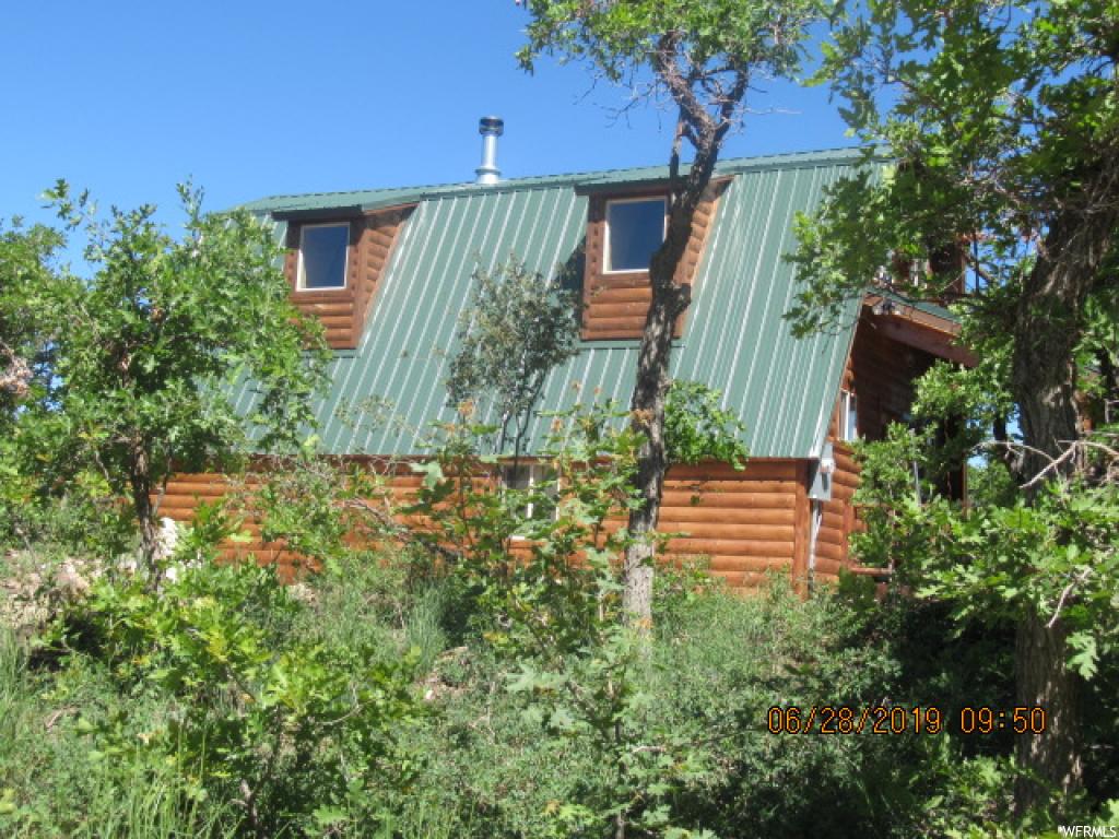 23075 JUNIPER DR N M-83 Fairview, Utah Beautiful Cabin that has been all redone!! Located on a larger lot (2.3 Acres) with Incredible Views. New upgrades including – new structural sheer walls before adding T&G was added, new metal roof, new flooring (LTV wood & carpeting), electrical, plumbing, windows (Low E & Insulated), large exterior water tank (1750 gallons), septic tank and drain field, new exterior log paneling (not panel siding), new T&G and log paneling inside, added insulation in exterior walls and ceiling), lights, new decks w/log railings, new fireplace and flues, new electric water heater, new cabinets, granite countertops, toilets, faucets, shower, tub, sinks, heated plumbing wrap in crawl space for winter use, new surround sound and low voltage pre-wiring, high definition antenna for TV, new gravel in half round drive, bistro lights on front porch, security motion sensor lights. When upgrading the cabin - the sellers took NO building permit to do these upgrades- improvements. The reason is because we treated these changes as 'upgrading and improving' the existing cabin and not as 'a remodel'. We did have an county building inspector who happened to be driving by stop and come in (when we were underway) and asked that question – 'are we remodeling or improving' and we explained improving/upgrading which is a fine line. Anyways for any technical improvements/upgrades we used only licensed subs to insure it was done correctly. I.e. - Mt Pleasant Power did do the power inspection when they connected the new meter. Seller want to disclose this so there's no issue. There is no warranty – Sellers are selling it 'as is.'