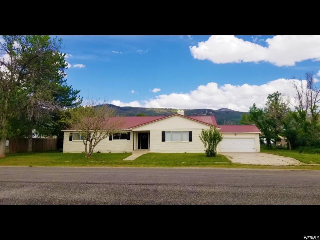 66 100 E N Fairview, Utah Stunning solid brick home situated on a 3/4 acre horse property with animal and irrigation water rights. This updated 3,425 sq. ft. home boasts 4 large bedrooms and 3 bathrooms, plus a workshop in the basement (that can be turned into an office, man cave, or 5th bedroom). A welcoming foyer leads the way to an extra-large and inviting living room with gorgeous marble covered fireplace. The kitchen, featuring white cabinets, brand new stainless steel appliances, a large pantry, and a breakfast nook opens up to a bright and spacious dining room overlooking the expansive yard and covered patio. The updated bathrooms have newly finished tiled showers, new bath fixtures, and statement mirrors. New light fixtures can be found throughout the house, and new carpet has been installed in the basement and master bedroom. Fresh exterior paint and new shutters add to the curb appeal of this beautiful home. Easy commute to Utah County. Beautiful views of the Manti La-Sal mountains. Enjoy country living at its best, away from the busyness of the city, and breath clean fresh air! Only a few minutes away from ATV trails, hunting, fishing, hiking and outdoor adventures. Wonderful quiet and desirable neighborhood, directly across the street from the Fairview Museum.