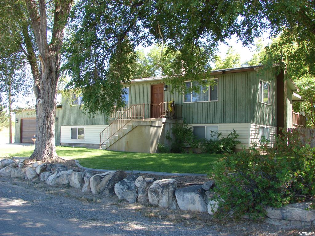 469 500 E S Spring City, Utah Beautiful quiet country living at its finest. Enjoy from your large deck your beautiful, fully landscaped yard with mature shade and fruit trees, large garden, private stream with a bridge and small pond. Great place to relax or entertain. Sheds, basketball court, playhouse! Finished Basement that features a large Family Room and Fireplace. Newly Remodeled Kitchen and Great Room that boasts amazing mountain views. Remodeled Master Bath. 4 shares horseshoe irrigation water included. (3 separate parcels make the 1.06 acres. Must be sold together) Call to find out how to get in this home with ZERO money down. Sale to include parcel numbers: 0000017539 000017603X