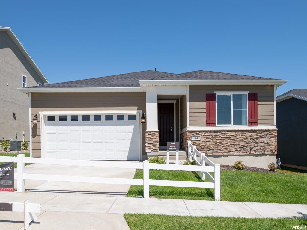 92 W SWAINSON AVE 10112 Saratoga Springs, Utah Thoughtful details bring this ranch-style model home to life. An open floor plan showcases a dining area, a central kitchen with a convenient island, and a great room with a fireplace, a tech center and access to the deck via center-meet sliding doors. The master suite is adjacent, complete with a walk-in closet and a private bath with double sinks. Two additional bedrooms and a full bath round out the residence.