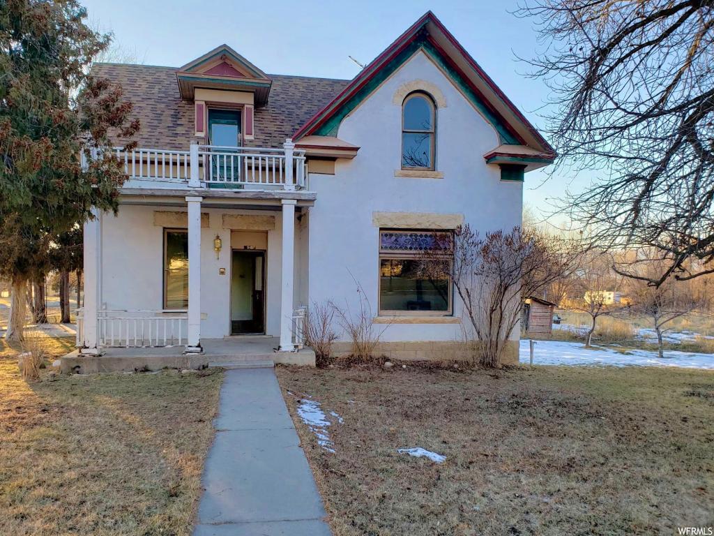 90 MAIN ST S Spring City, Utah Downtown Historic Spring City Charmer. This turn-of-the-century home was built in 1911 and is quaintly located next to the white brick historic Spring City church. With large, oolite brick windows that showcase the spectacular stained-glass window detail. This home has original hardwood in the front room and living room and a wood-burning stove. This 4 bedroom 2 bathroom home sits on .69 acres and includes a storage/washer room, shed, and even an original outhouse. Also includes a natural free-flowing spring. This property is situated on Main Street and has commercial property potential. Also includes four shares of water.