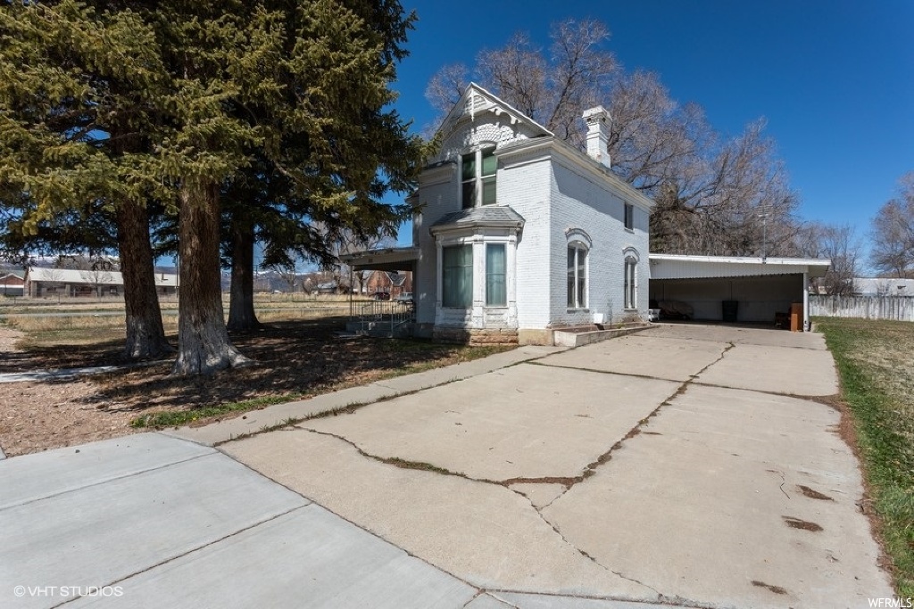 88 100 S ST S W Moroni, Utah Come check out one of the more elegant homes in Moroni from the late-nineteenth century. This historic two-story brick Victorian style home is constructed with an angular front bay window, paired upper windows, with main level windows trimmed with segmented brick arches. The inside consists of ornamental trim and elegnt recessed entryway - all typical of the late 19th century. Upon approaching this home you'll immediately notice the majestic fir trees planted in the late 1860s. This home has so much potential and would make a great primary or secondary residence - or consider turning into an Airbnb. Additional space in the attic has room for future loft. Home sits on a large corner lot with recently installed sidewalks by city. Buyer's agent must accompany Buyers at all times. Sq feet figures obtained from appraisal however, buyer is advised to obtain an independent measurement.