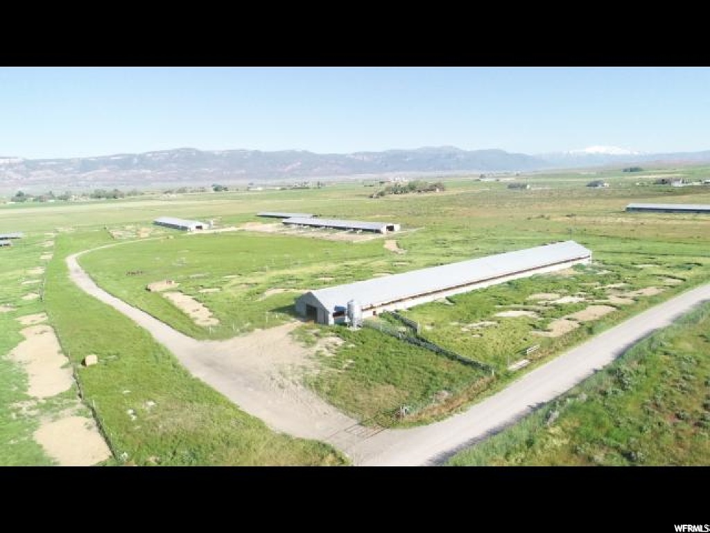 1300 5100 E N Chester, Utah 2 AC FT WATER RIGHT INCLUDED. Come enjoy the beautiful views of Skyline Drive (Manti La Sal Mountains). Being only 3 miles from Spring City, you can be on the mountain within minutes from leaving your property. Sanpete County is ATV friendly. It has an older turkey barn with a grain silo. It has been used in the past for turkeys and making pallets. The barn can be used for countless things, bring your horses or ATVs. Many older turkey sheds have been bought and used for horses and sheep. Natural gas is already hooked up at the building. There is power to barns but new service will be needed. Additional water is available for purchase. Square footage figures are provided as a courtesy estimate only and were obtained from Sanpete County. Buyer is advised to obtain an independent measurement.