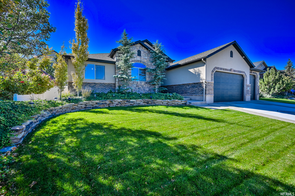 5719 W EMMELINE DR Herriman, Utah Fabulous home located in quiet Herriman neighborhood with many custom upgrades. Enjoy the open concept floor plan. Kitchen has large island, granite countertops, recessed lighting, and tall cabinets. Primary bedroom features a cozy gas fireplace. Finished basement has 3 additional bedrooms, den, bathroom and large family room with storage space to spare. Fully-fenced private backyard with covered patio, perfect for entertaining. 3 car garage with the drive through 3rd bay to backyard (RV Parking). Well Maintained including new furnace and A/C. Check out the video tour and 3D virtual tour!