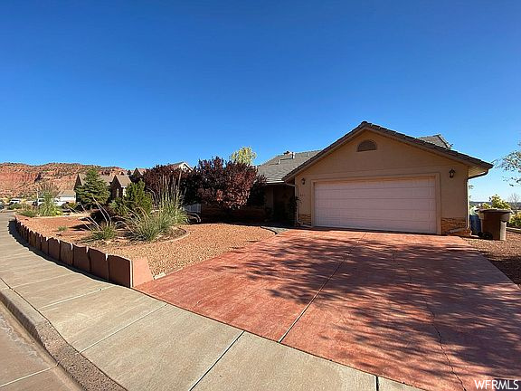 830 E COUNTRY CLUB DR Kanab, Utah The theme throughout this well-designed 2,400 sq. ft. home is its functional openness and breathtaking views. Beautifully custom made with skill and sense for detail, it boasts 3 bedrooms with one full, one 3/4 , and 2 half-baths. Tall ceilings, spacious kitchen with appliances under 1 year old and cabinets made of high-quality distressed maple. Lots of storage space and fully landscaped yard. Home sits on .26 acre lot and is structurally engineered for the area, built on piers. Mature trees fully and landscaped yard.
