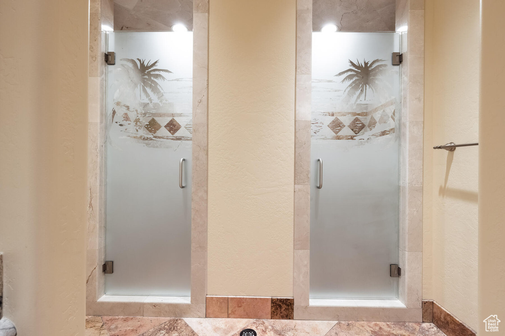 Bathroom featuring an enclosed shower and tile floors