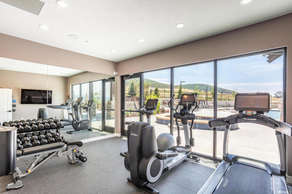 Workout area featuring natural light and TV