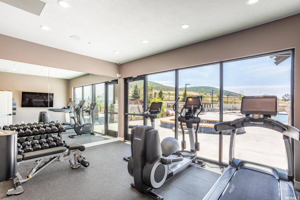 Exercise room featuring natural light and TV