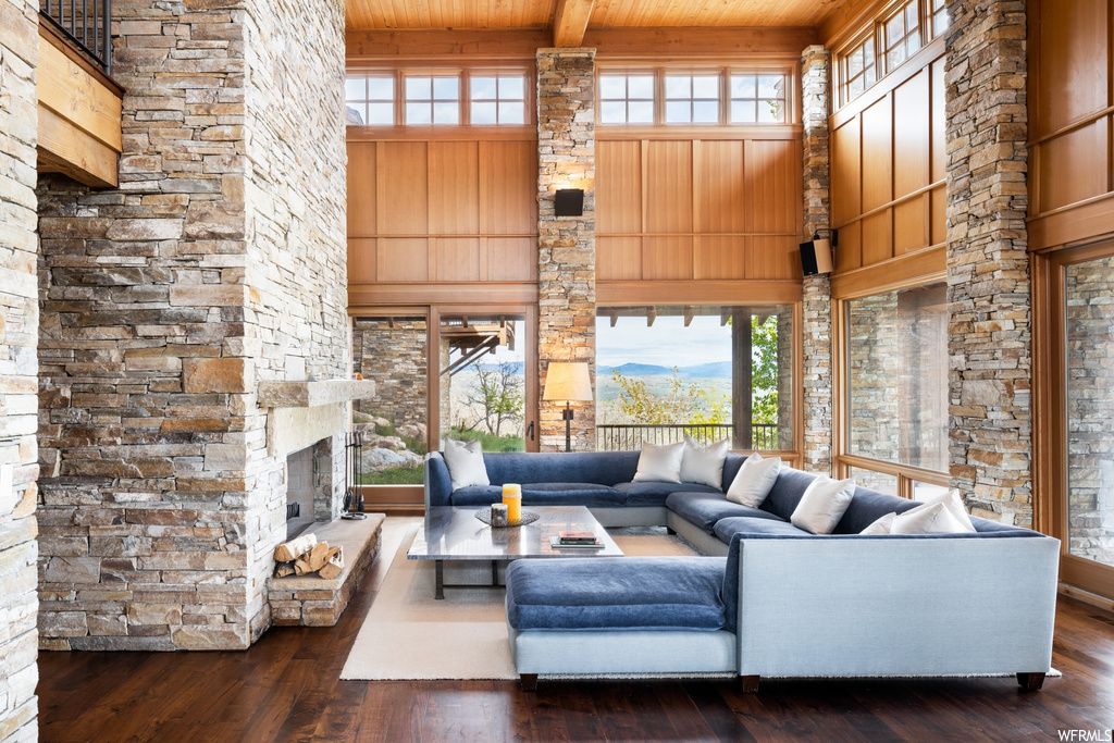 hardwood floored living room with a fireplace and a wealth of natural light