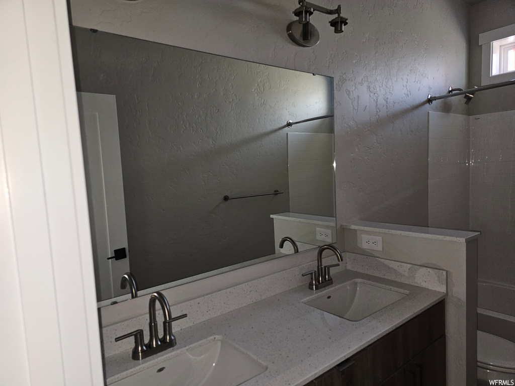 Bathroom featuring mirror and dual large bowl vanity