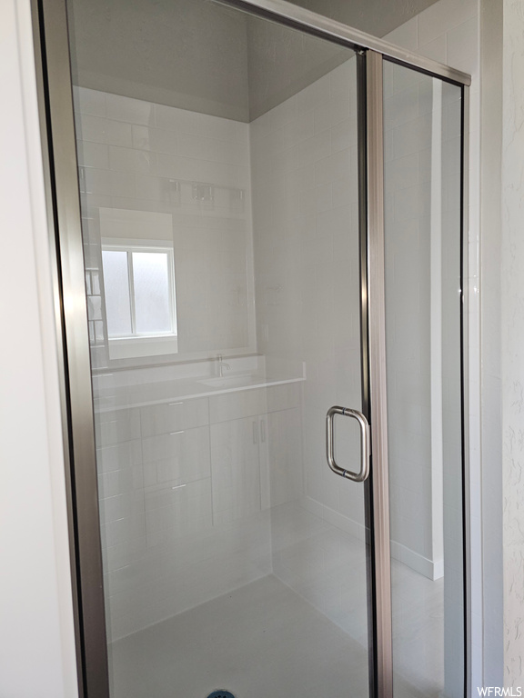 Bathroom featuring a shower with door