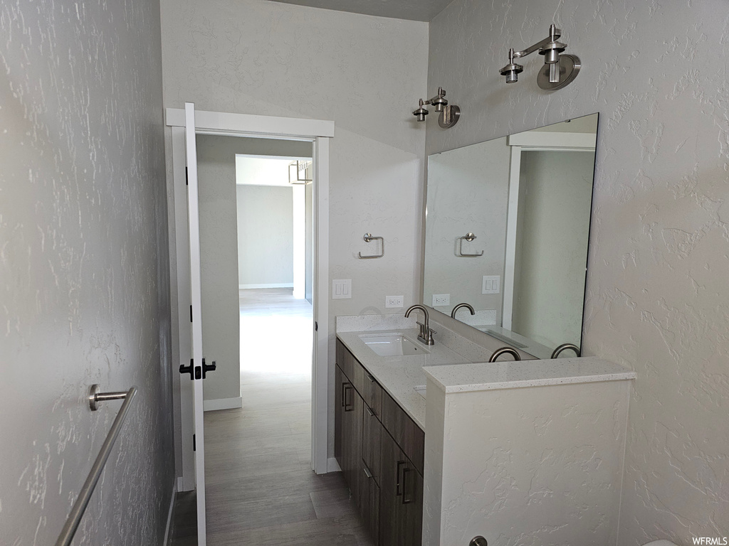 Bathroom featuring light parquet floors, mirror, and oversized vanity