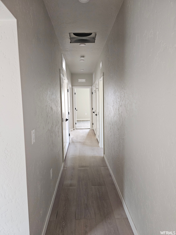 Hallway featuring hardwood flooring