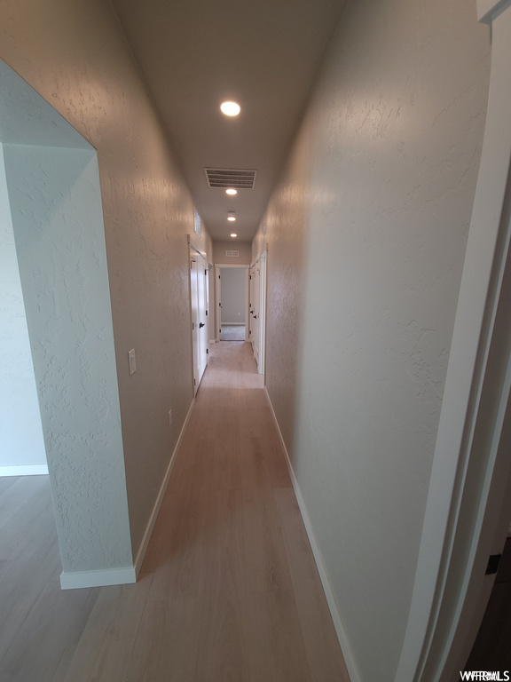 Hallway with hardwood flooring