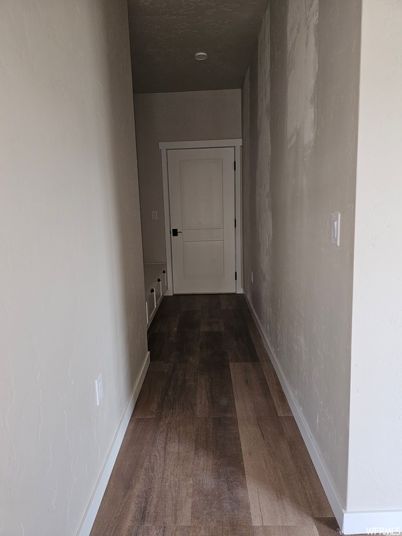 Hall featuring dark hardwood flooring