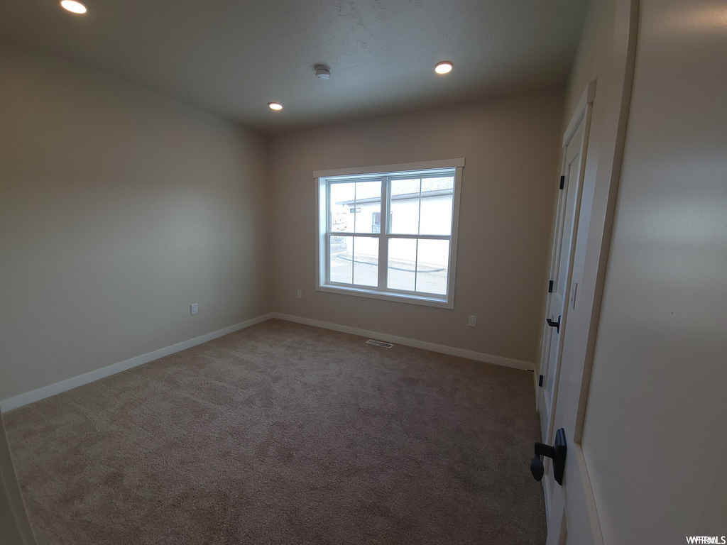 Empty room with carpet and natural light