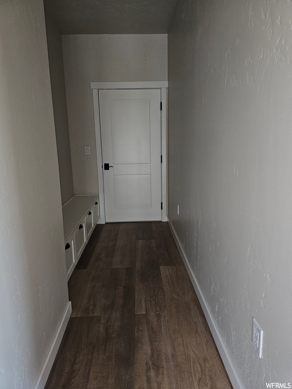 Corridor featuring dark hardwood flooring
