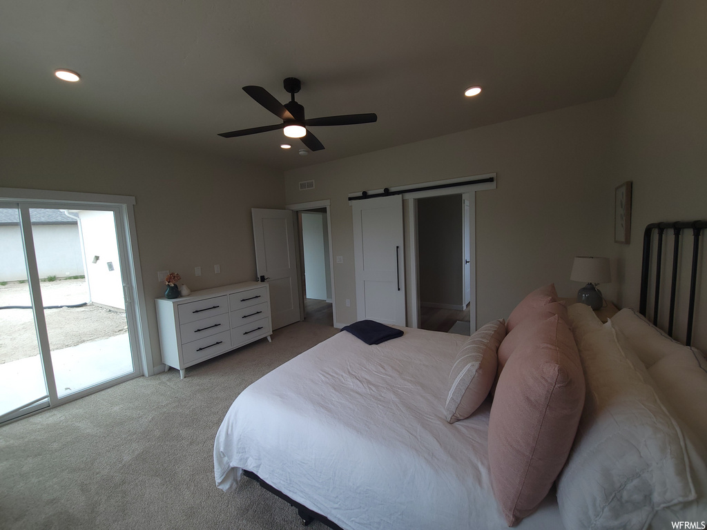 Bedroom with a ceiling fan, carpet, and natural light
