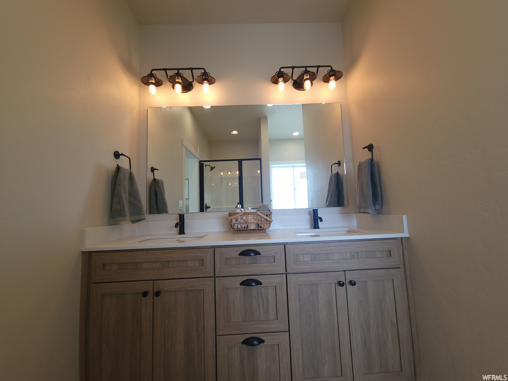 Bathroom featuring double vanities and multiple mirrors