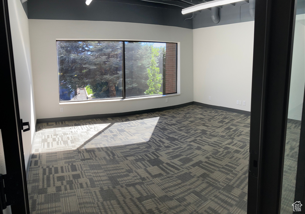 Carpeted empty room with baseboards