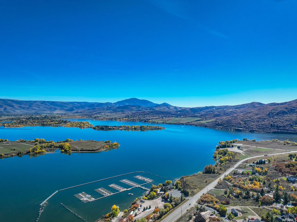 Drone / aerial view with a water and mountain view