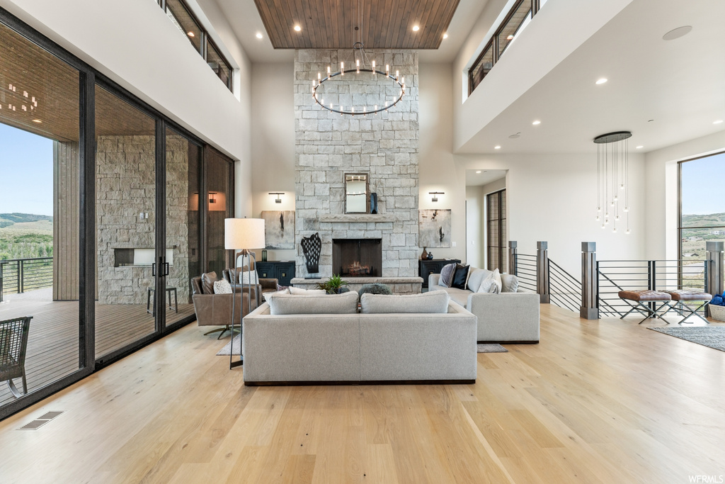 Living room featuring a high ceiling and light hardwood floors