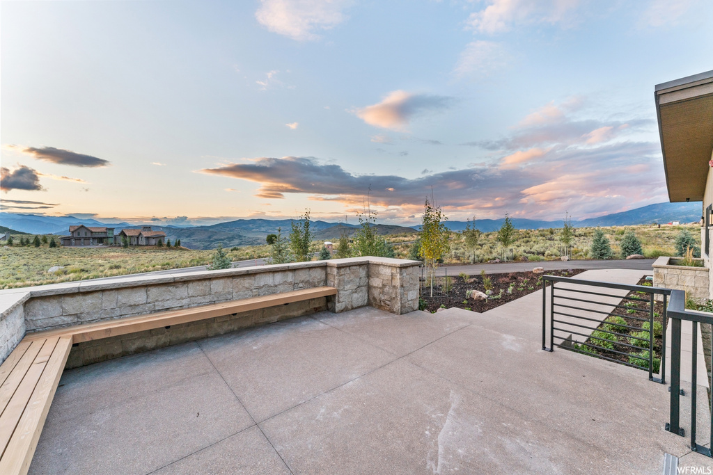Patio terrace at dusk with a mountain view