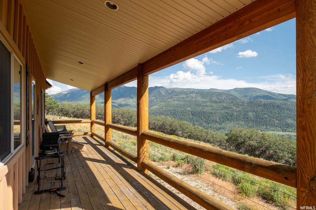 wooden deck featuring a mountain view