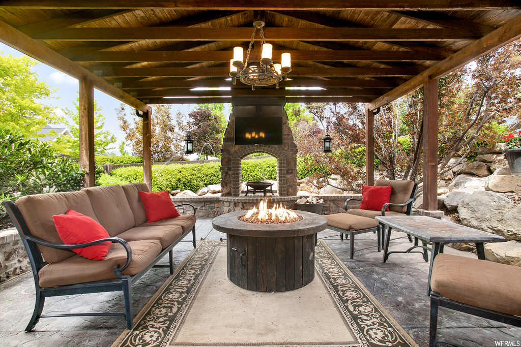 view of patio / terrace with an outdoor living space with a fireplace