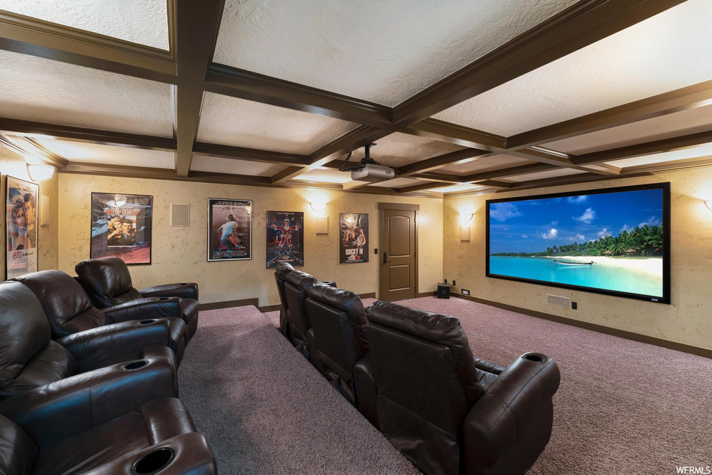 home theater room featuring coffered ceiling, carpet, and TV