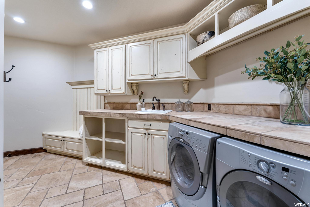 clothes washing area with tile floors and independent washer and dryer