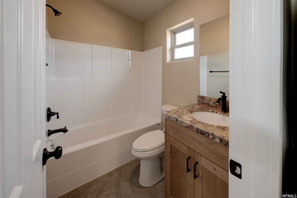 full bathroom with natural light, tile flooring, shower / bathtub combination, mirror, toilet, and vanity with extensive cabinet space