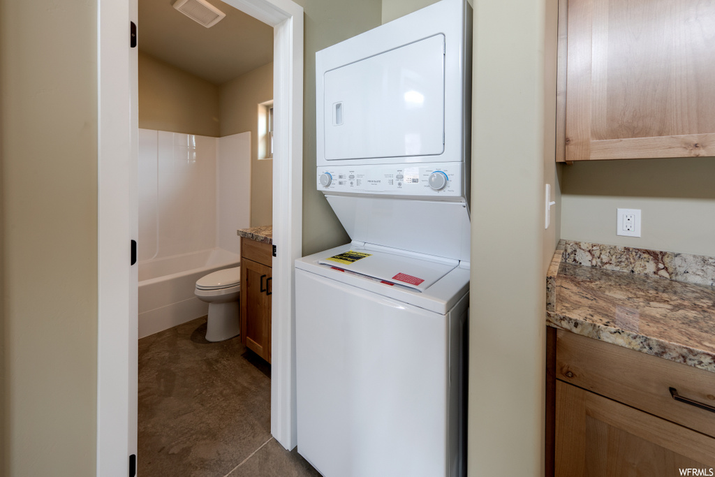 laundry room featuring tile flooring and washer / dryer