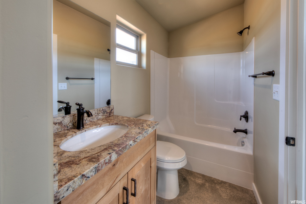 full bathroom featuring natural light, vanity with extensive cabinet space, shower / washtub combination, toilet, and mirror