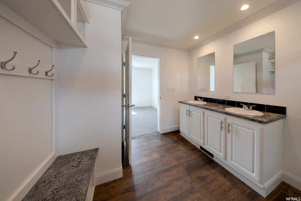 kitchen featuring dark hardwood flooring and white cabinetry