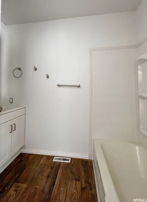 Bathroom featuring wood-type flooring and shower / bathtub combination