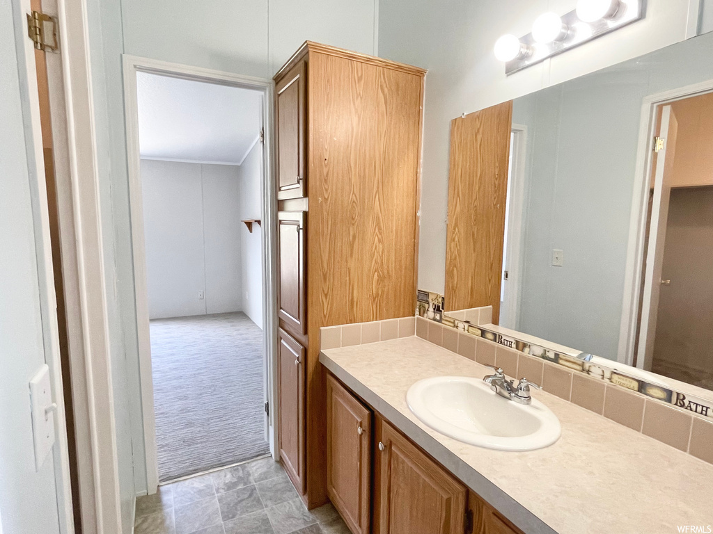 Bathroom featuring tile floors, oversized vanity, and mirror