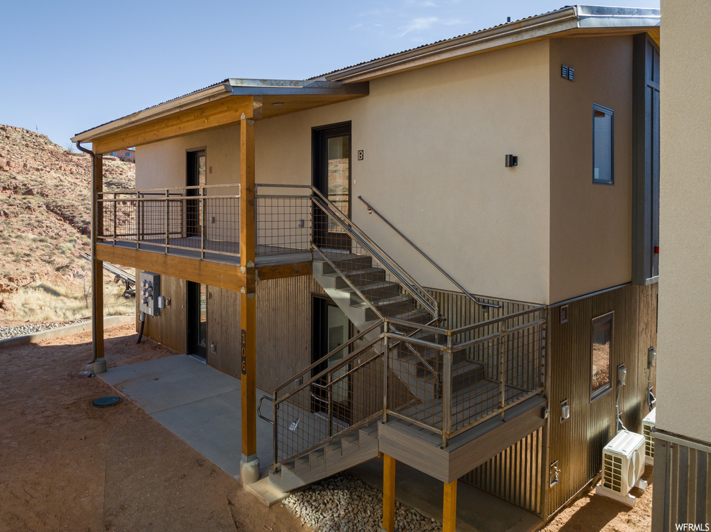 Rear view of property with a balcony and central AC unit