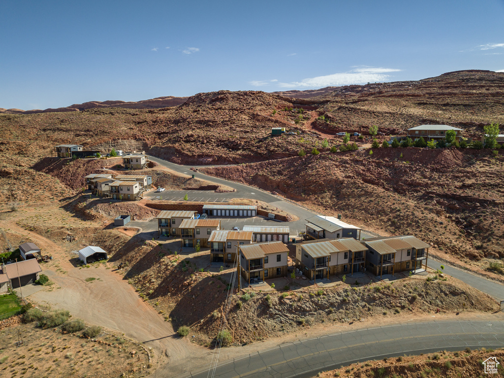 Aerial view of property and surrounding area featuring a mountainous background