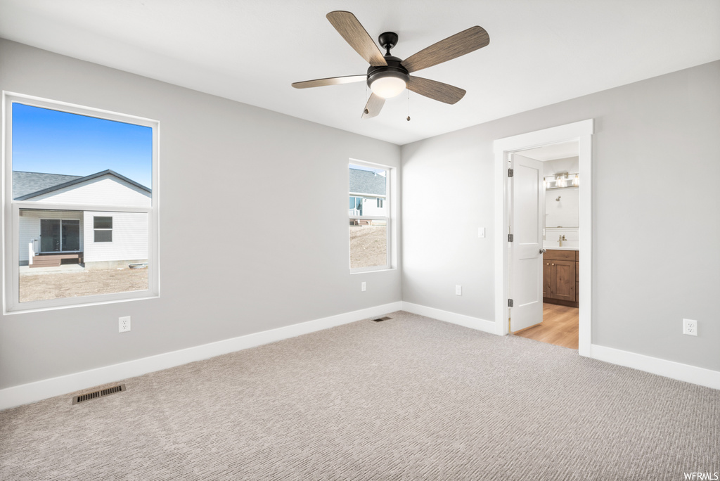 bedroom featuring natural light, hardwood flooring, and a ceiling fan